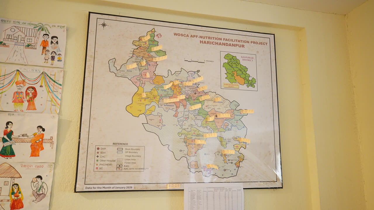 A framed district project map on the office wall in Harichandanpur