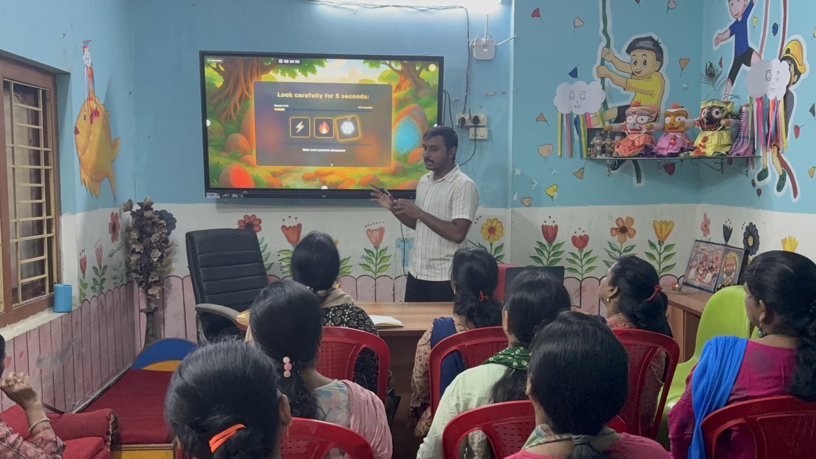 Training facilitator presenting to teachers with a screen during a session